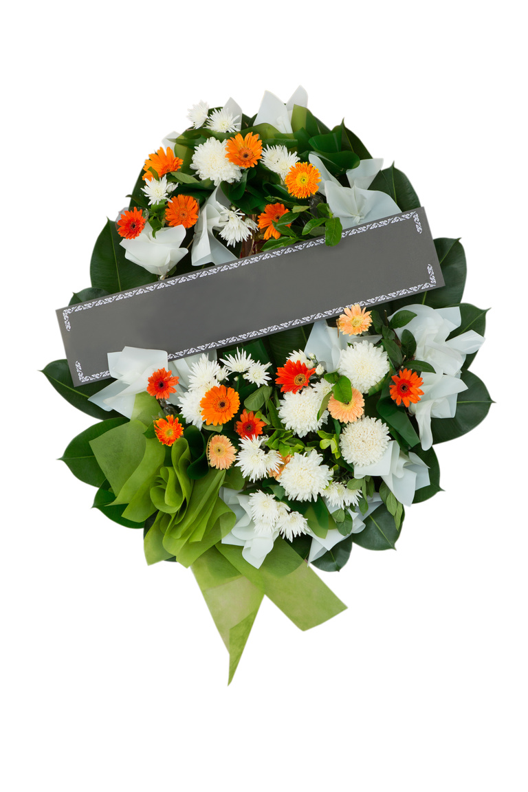 Funeral wreath with orange and white flowers and a green bow